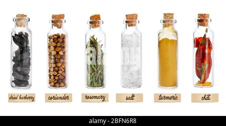 Set of different spices in glass jars. Isolated on white Stock Photo