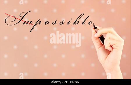 Human hand turning word impossible into possible Stock Photo