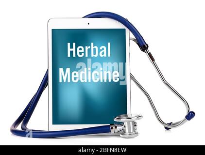 Stethoscope and tablet with text HERBAL MEDICINE on screen. Alternative medicine concept. Stock Photo