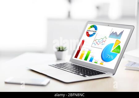 Modern workplace at office. Business presentation on laptop screen. Stock Photo