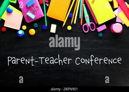 Text PARENT-TEACHER CONFERENCE with stationary on blackboard background. School concept. Stock Photo