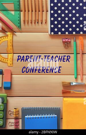 Text PARENT-TEACHER CONFERENCE and stationery on wooden background. School concept. Stock Photo