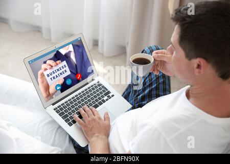 Man video conferencing on laptop. Webinar and consultation online. Modern business technology concept. Stock Photo