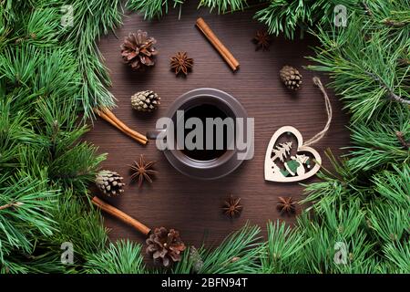 Christmas composition. A Cup of coffee, cones and Christmas toys on a wooden background. The decoration of Christmas wreaths. Winter, new year concept Stock Photo