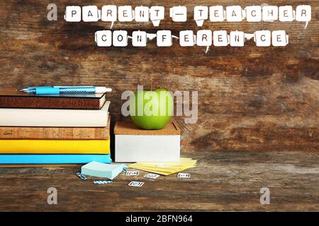 Stationary with text PARENT-TEACHER CONFERENCE on wooden background. School concept. Stock Photo