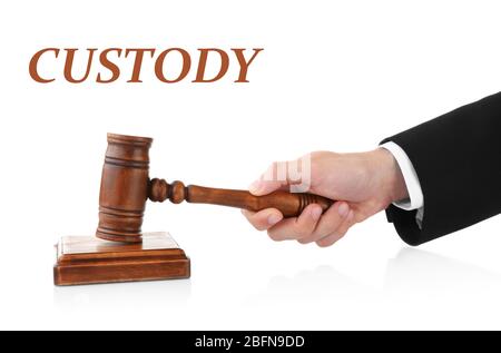 Male hand with judge's gavel and word CUSTODY on white background Stock Photo