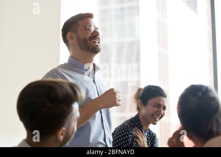 Multi-ethnic corporate team laughing during briefing in office Stock Photo