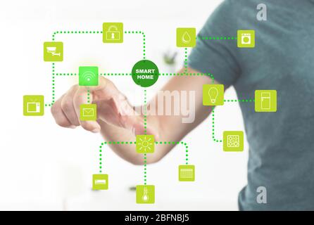 Man using smart home application on virtual screen. Innovation technology concept. Stock Photo