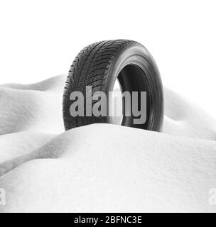 Car tire in snowdrift on white background. Winter tires concept. Stock Photo