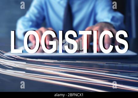 Logistics concept. Man with tablet and blurred traffic lights Stock Photo