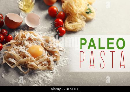 Paleo pasta concept. Raw pasta and yolk on table Stock Photo