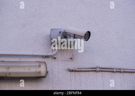 Urban security camera on the wall Stock Photo