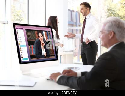 Man video conferencing with lawyer on computer. Video call and online service concept. Stock Photo