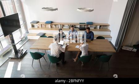 View from above diverse business people negotiating in board room Stock Photo