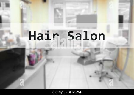 Text HAIR SALON on blurred barbershop interior Stock Photo