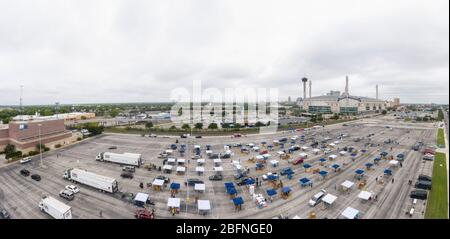 Aerial view of hundreds of cars lined up to receive USDA Food and Nutrition Service and San Antonio Food Bank food aid to families suffering from the effects of the COVID-19, coronavirus pandemic at the Alamodome April 17, 2020 in San Antonio, Texas. Stock Photo