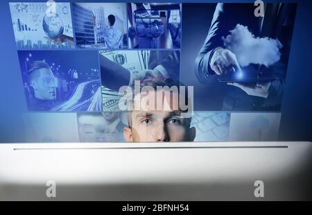 Internet and modern technology concept. Young man working with computer Stock Photo
