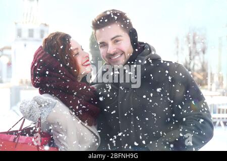 Young couple in snowfall outdoor Stock Photo