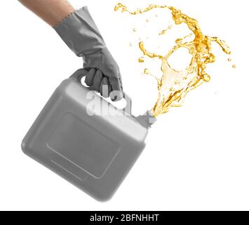 Man pouring oil out of plastic canister on white background Stock Photo