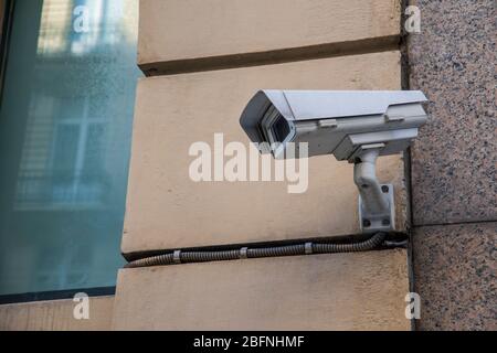 Urban security camera on the wall Stock Photo