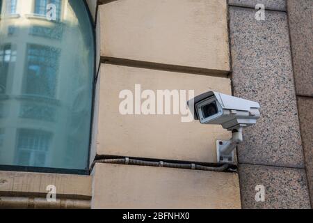 Urban security camera on the wall Stock Photo