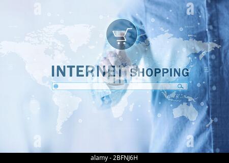 Man pushing shopping cart button of internet store on virtual screen Stock Photo