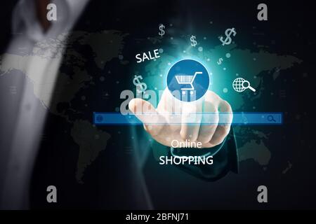 Man pushing shopping cart button of internet store on virtual screen Stock Photo