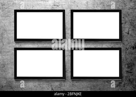 Modern TV screens on grey wall background Stock Photo