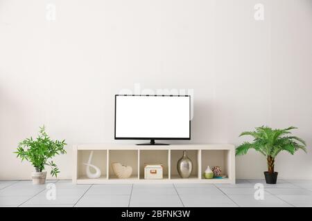 Blank TV display on stand in living room Stock Photo