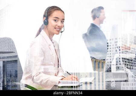Double exposure of cityscape view and woman working at table in office. Concept of financial trading Stock Photo