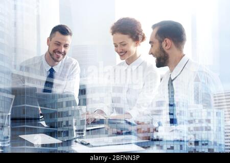 Double exposure of cityscape view and people working at table in office. Concept of financial trading Stock Photo