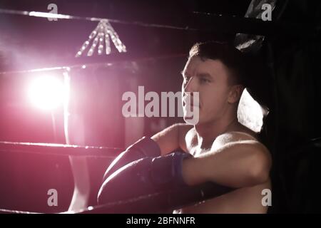 Professional boxer having break during training in ring Stock Photo