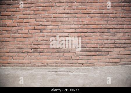 View of an old brown brick wall with rich colorful grainy texture and details. Textured abstract background. Stock Photo