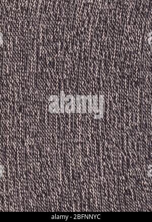 Texture of knitted fabric. Cold weather background. Warm black and white wool sweater texture. Knitted fabric background. Stock Photo