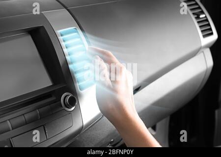 Driver checking flow of cold air from conditioning system in car Stock Photo