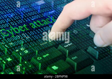 Man hacking computer and pushing enter button on keyboard. Concept of cyber attack and security Stock Photo