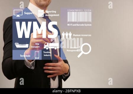Warehouse management system concept. Man working with virtual screen Stock Photo