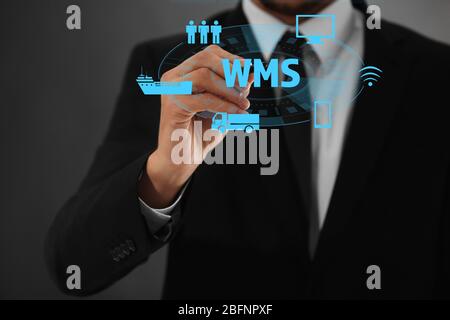 Warehouse management system concept. Man working with virtual screen Stock Photo