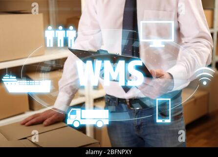 Warehouse management system concept. Man working at factory facility Stock Photo