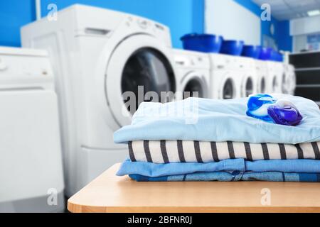 Clean clothes with gel pods at self-service laundry Stock Photo