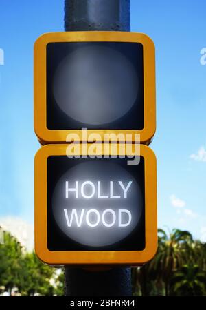 Green traffic light with word HOLLYWOOD on sky background Stock Photo