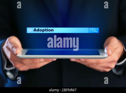 Adoption concept. Male hands with tablet and search box Stock Photo