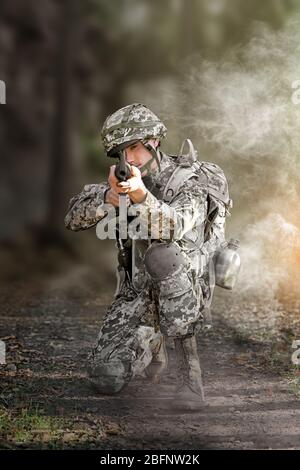 Soldier taking aim from rifle in forest, close up view Stock Photo - Alamy
