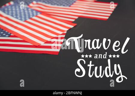 USA flags and text TRAVEL AND STUDY on blackboard background Stock Photo