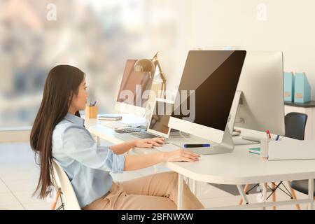 Young female programmer working in office Stock Photo