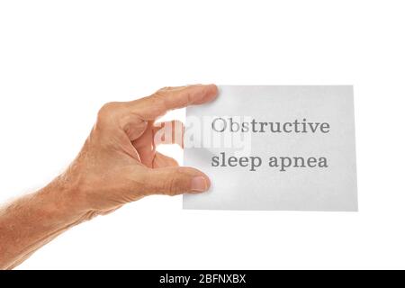 Old man holding paper with text OBSTRUCTIVE SLEEP APNEA on white background Stock Photo