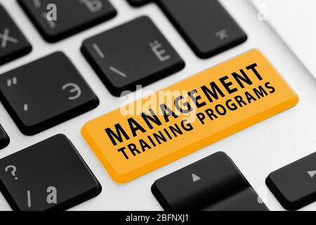 MANAGEMENT TRAINING PROGRAMS button on keyboard, closeup Stock Photo
