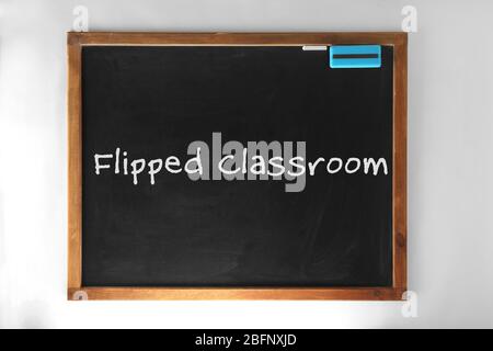 Flipped classroom concept. Inversed blackboard on white background Stock Photo