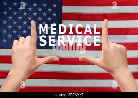 Text MEDICAL SERVICE and female hands on USA flag background Stock Photo