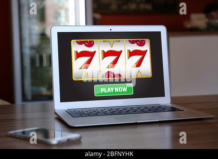 Laptop with online casino app on table indoors Stock Photo